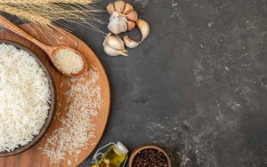 Ingredienti per fare il risotto, riso crudo, olio, aglio e pepe